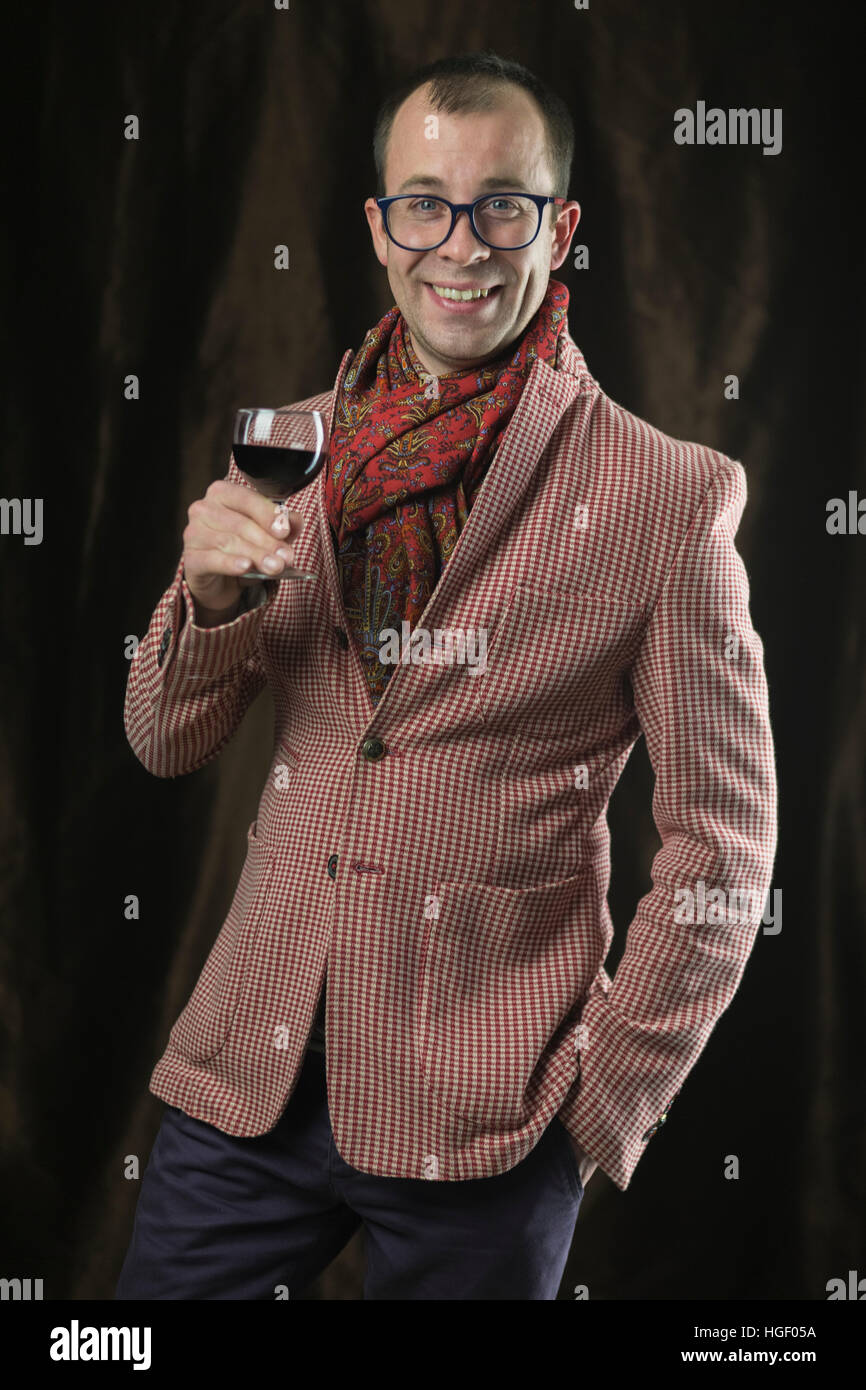 The man in glasses tasting red wine, emotions. Stock Photo