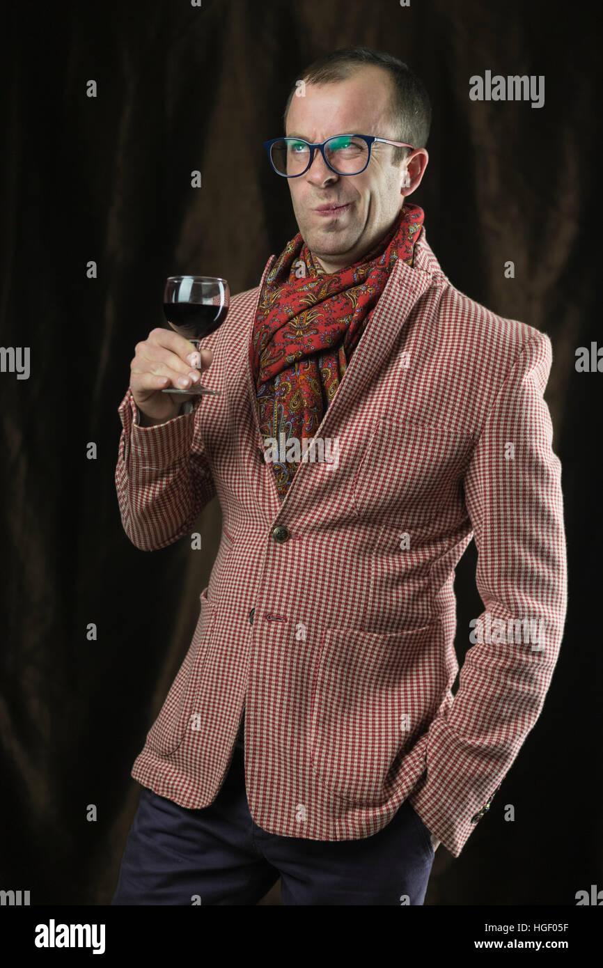 The man in glasses tasting red wine, emotions. Stock Photo