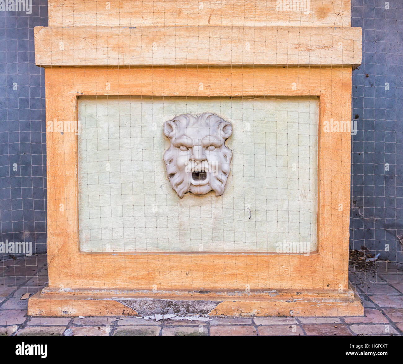 Forli, Italy, wall face sculpture with opened mouth Stock Photo