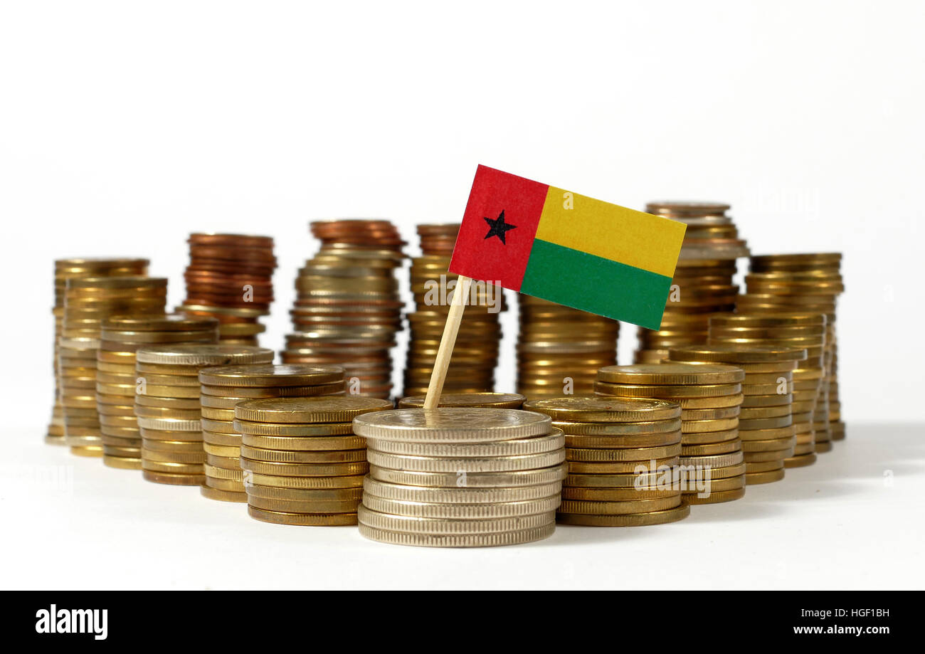 Guinea Bissau flag waving with stack of money coins Stock Photo