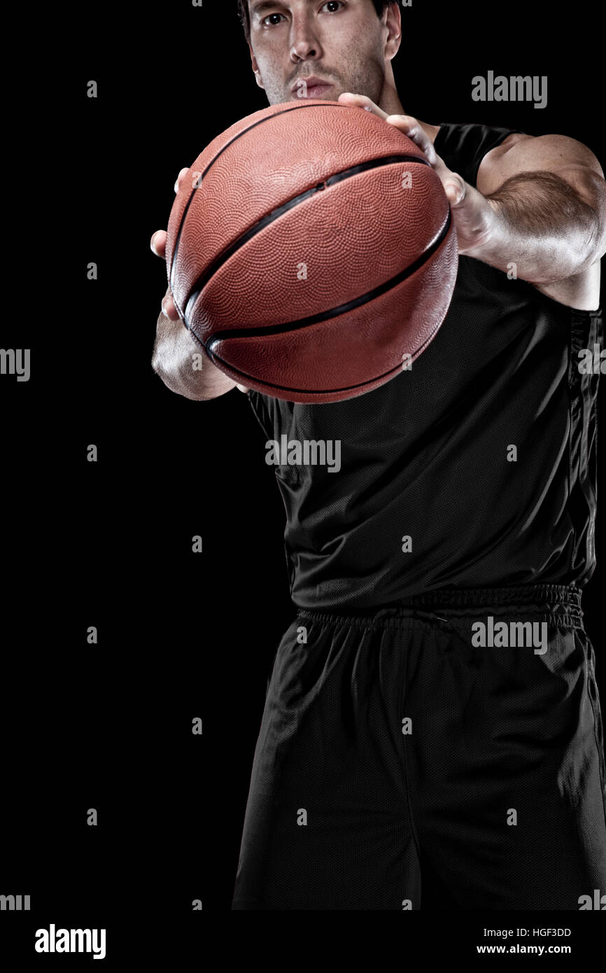 Basketball player with a Black uniform on a black background Stock