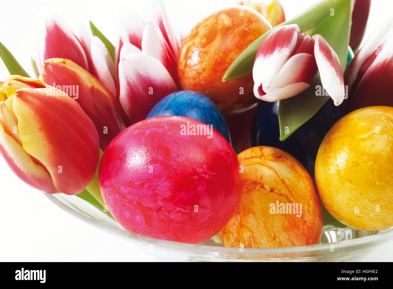 Glass bowl with painted Easter eggs and tulips Stock Photo - Alamy