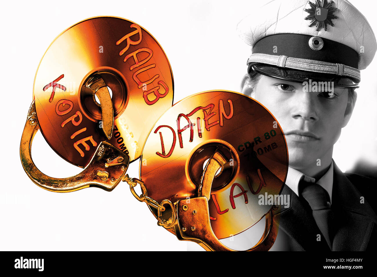 Handuffs and CD/DVD, police officer in background: symbolic for data theft crime Stock Photo