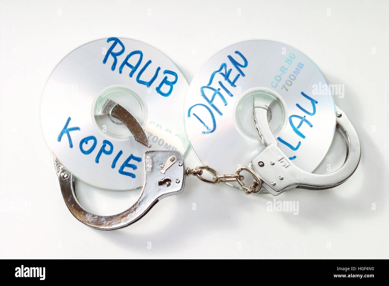 Handuffs and CD/DVD: symbolic for data theft crime Stock Photo