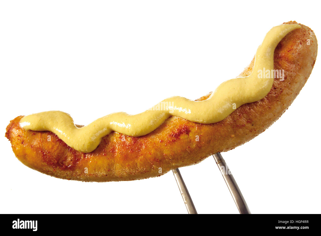 Bratwurst (sausage) with mustard on a meat fork Stock Photo Alamy