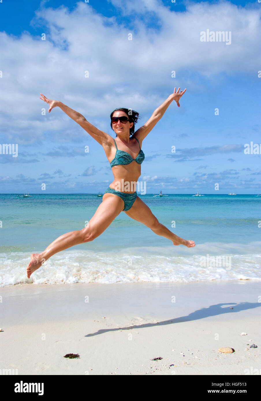 Young woman jumping on the beach Stock Photo Alamy