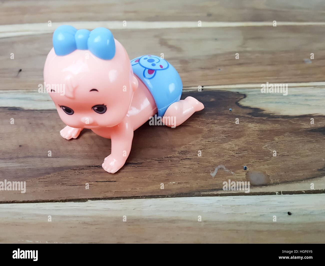 Mechanical wind up crawling baby toy on wood background Stock Photo Alamy