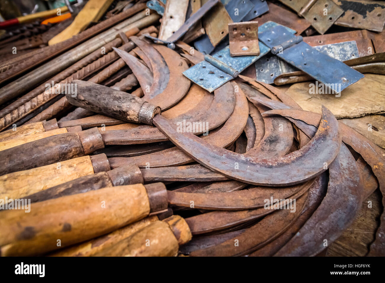 Old rusted scythes for sale on the market in Madagascar Stock Photo