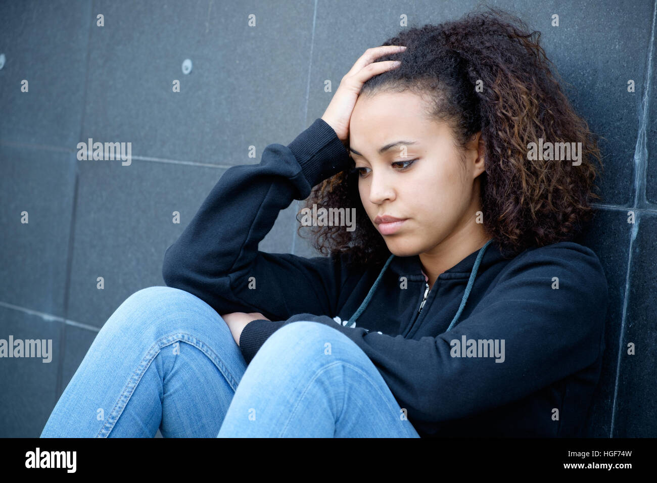 Sad and lonely teenager portrait in the city street Stock Photo