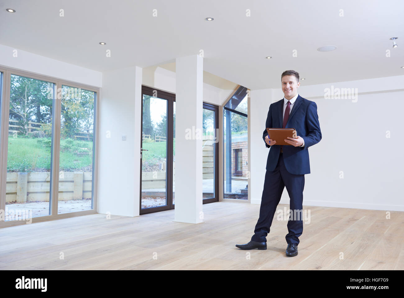 Estate Agent Looking Around Vacant Property For Valuation Stock Photo