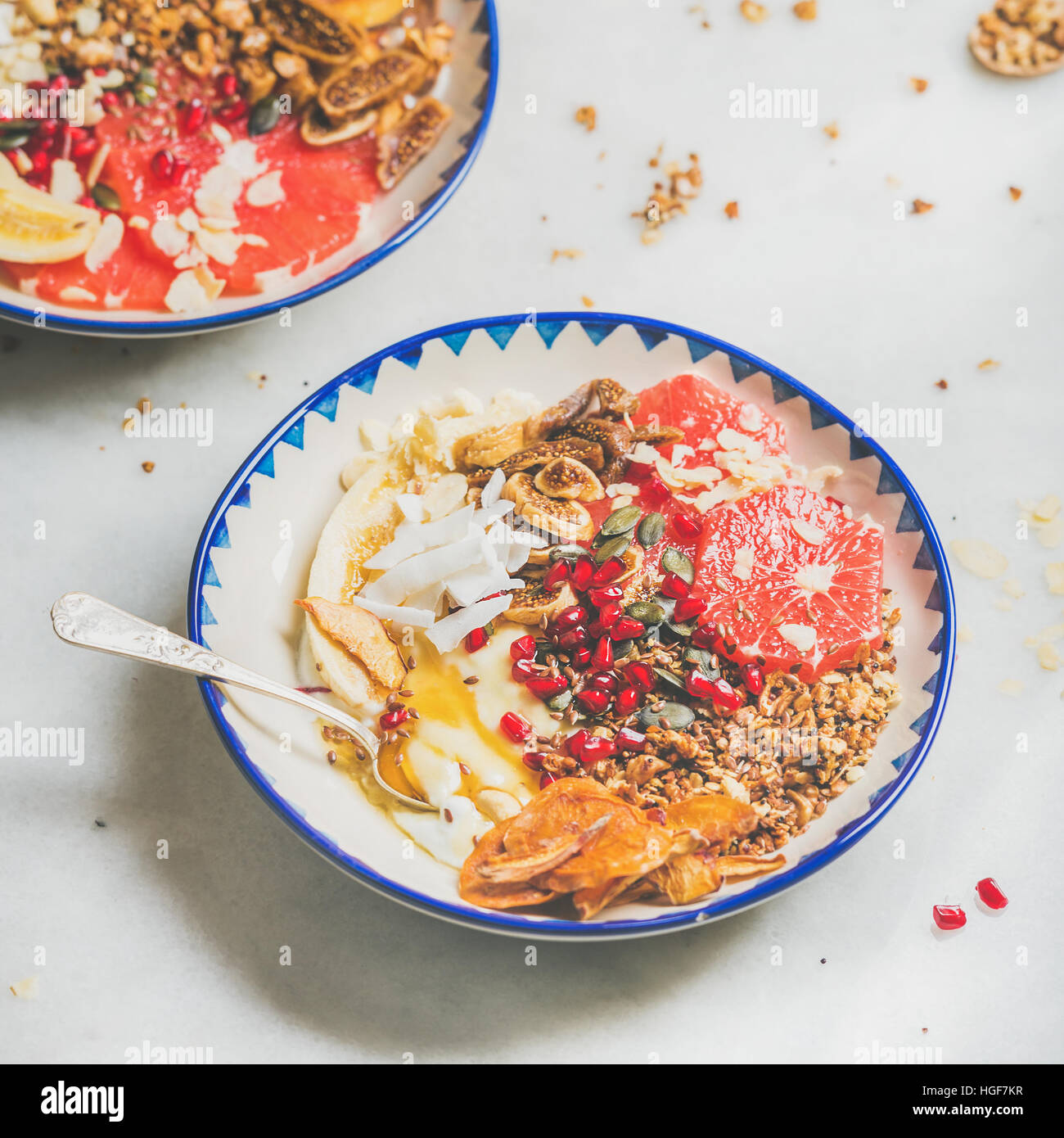 Healthy breakfast yogurt bowls with seeds, fruit, nuts, granola Stock