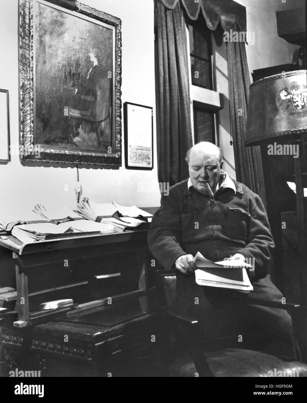 Winston Churchill in his office under a portrait of his wife Clementine. Chartwell. 1947 Stock Photo
