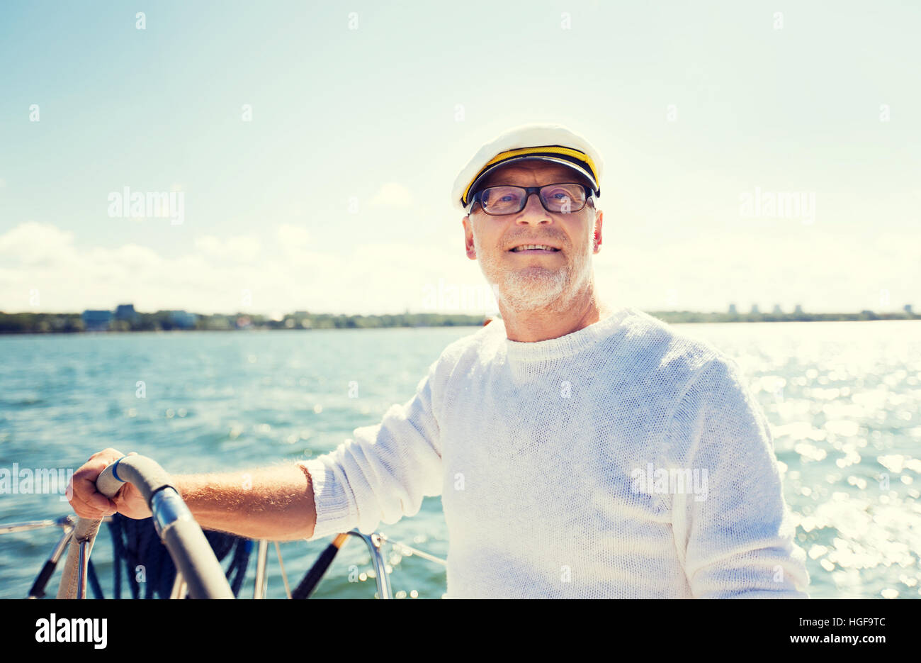 senior man at helm on boat or yacht sailing in sea Stock Photo - Alamy