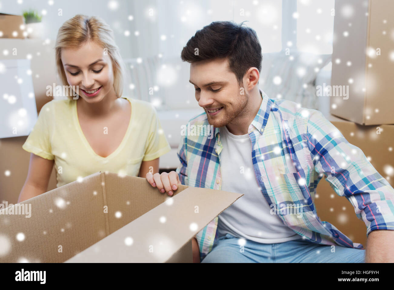 smiling couple with big boxes moving to new home Stock Photo - Alamy