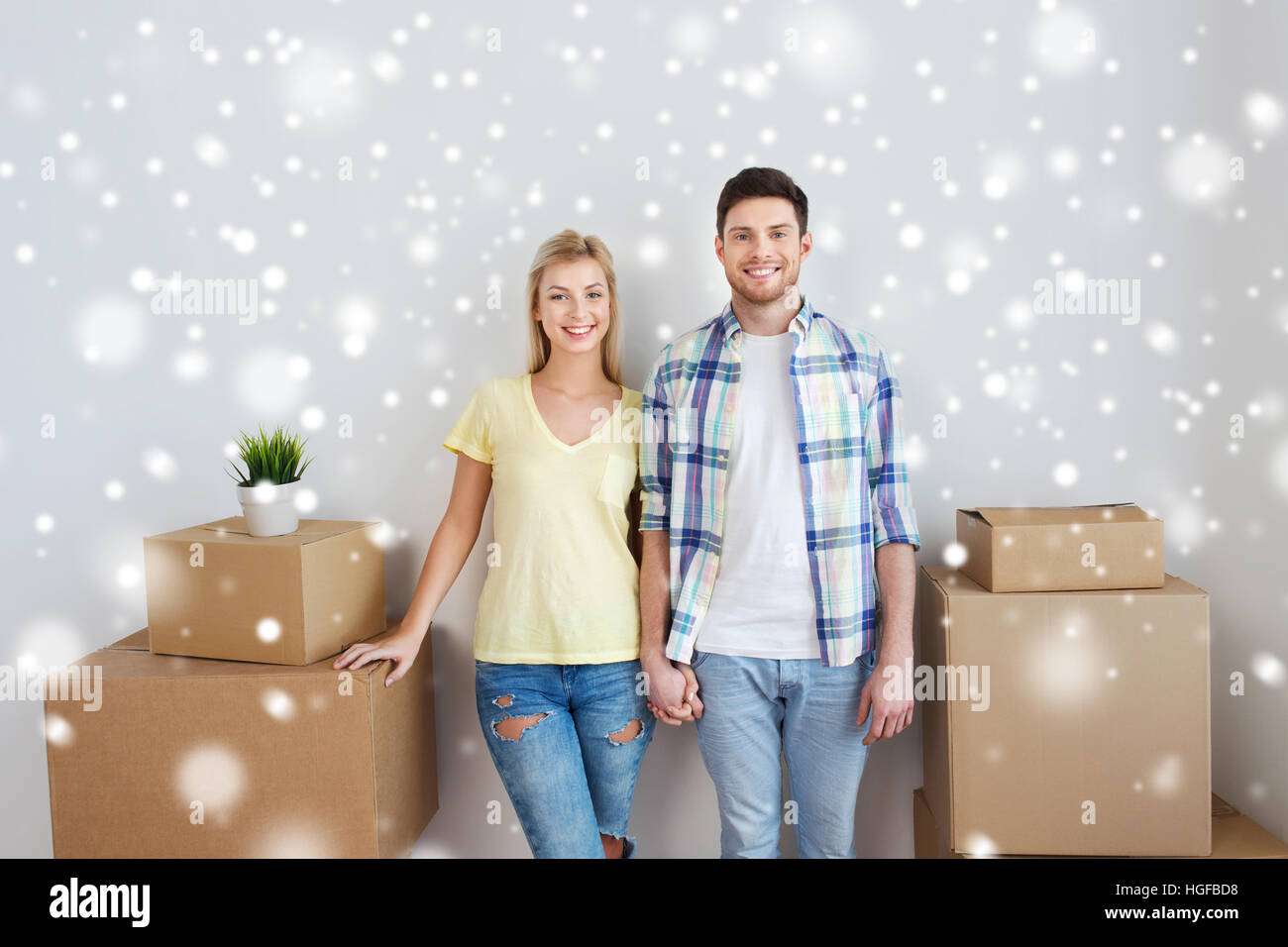 smiling couple with big boxes moving to new home Stock Photo - Alamy
