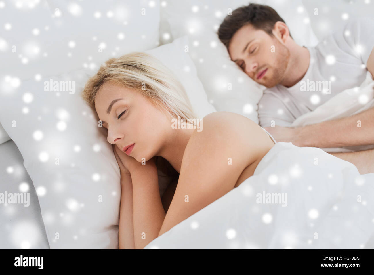 happy couple sleeping in bed at home Stock Photo