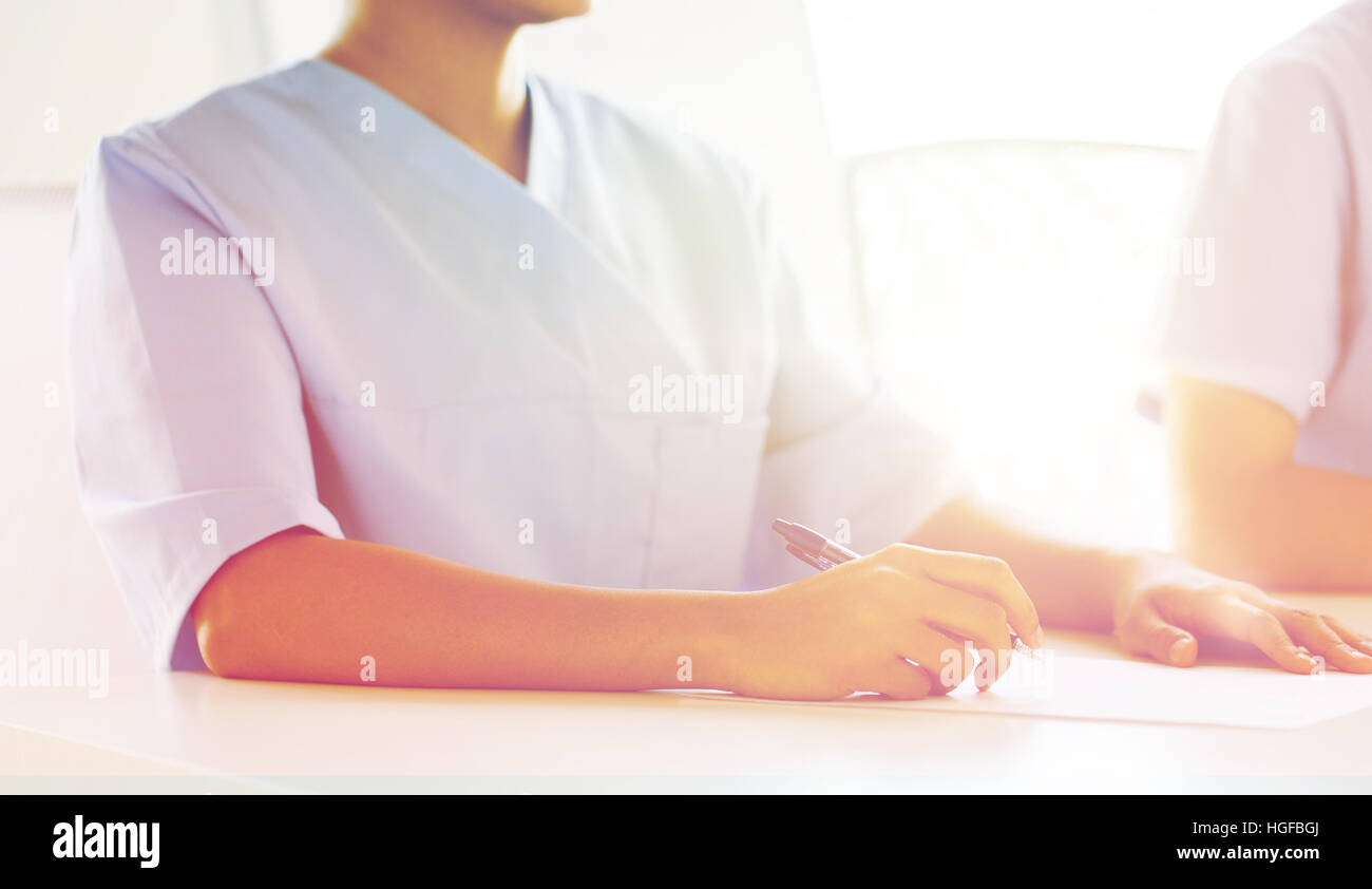 close up of doctor taking notes at hospital Stock Photo - Alamy