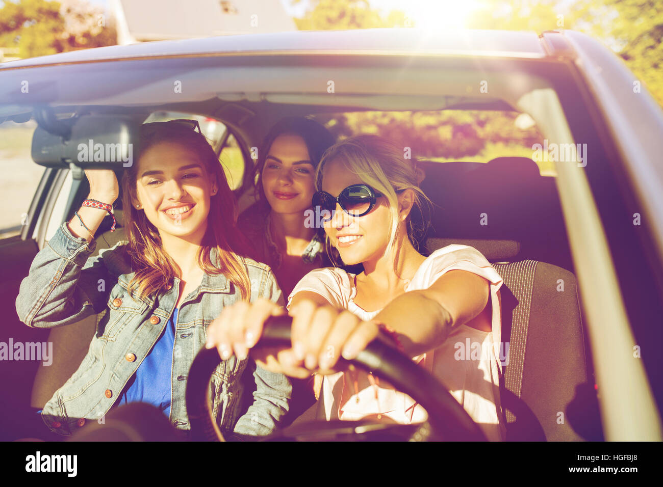 happy teenage girls or young women driving in car Stock Photo - Alamy