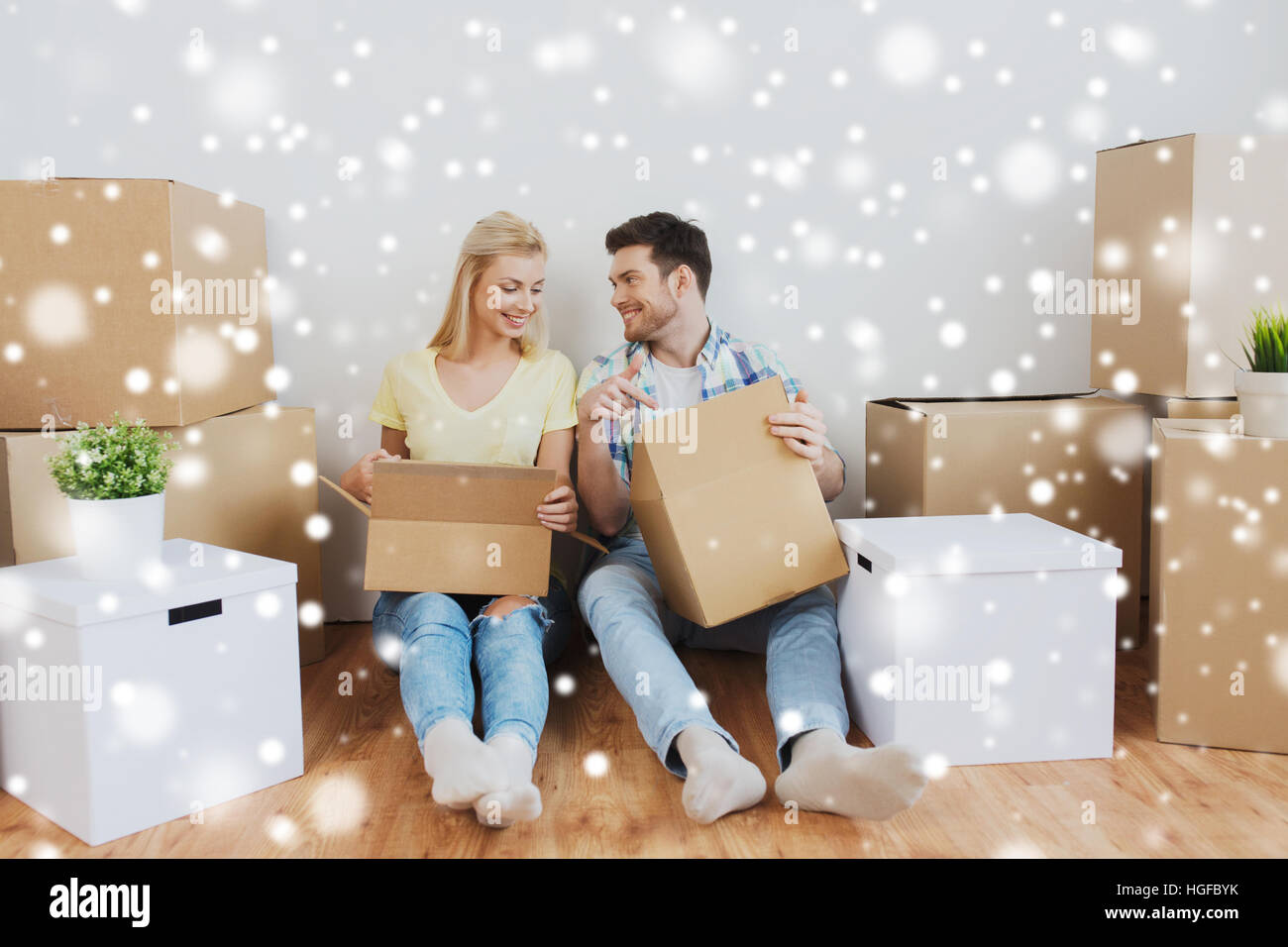smiling couple with big boxes moving to new home Stock Photo - Alamy