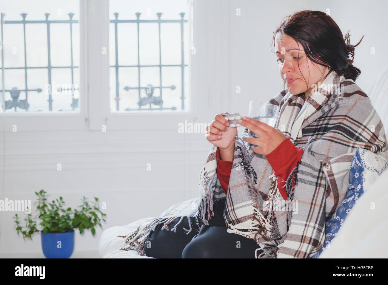 flu and fever, sick cold woman at home taking medicine pills Stock Photo
