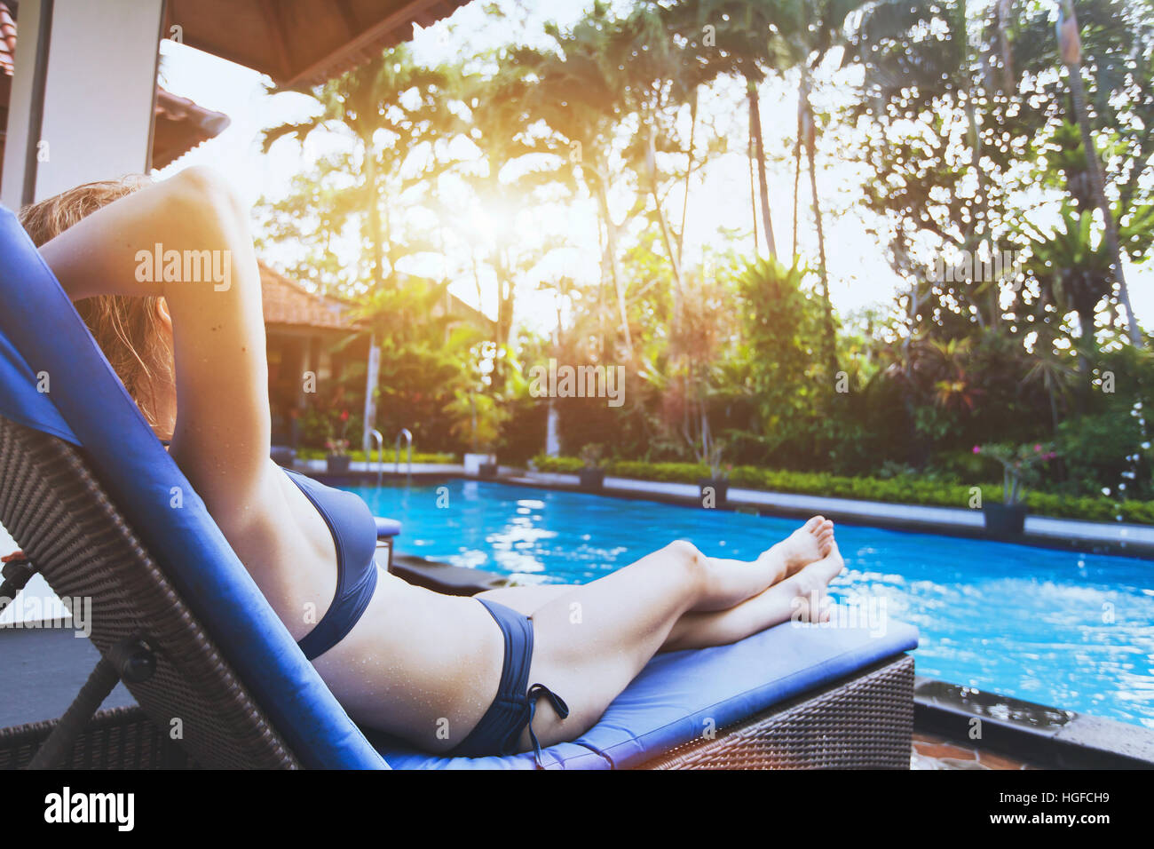 people relaxing in luxury tropical resort hotel near swimming pool Stock Photo