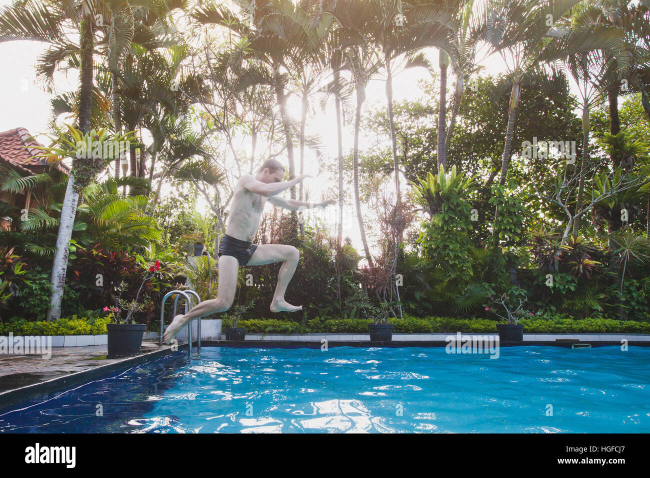 happy tropical holidays, jumping to the swimming pool in hotel Stock Photo