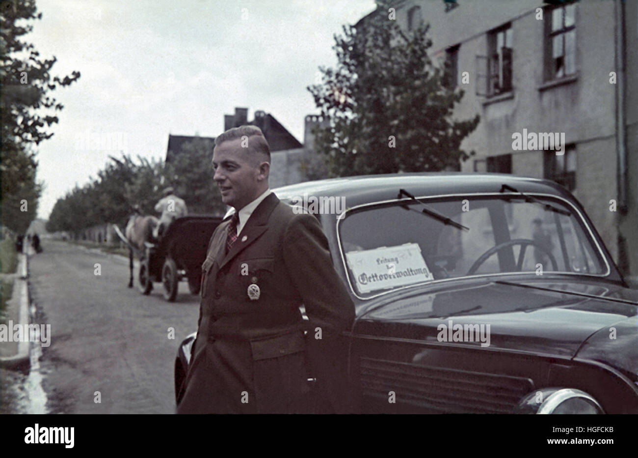 Ghetto Lodz, Litzmannstadt, Hans Biebow, chief of German Nazi administration of the Lodz ghetto poses in front of his car, Poland 1940, World War II, Stock Photo