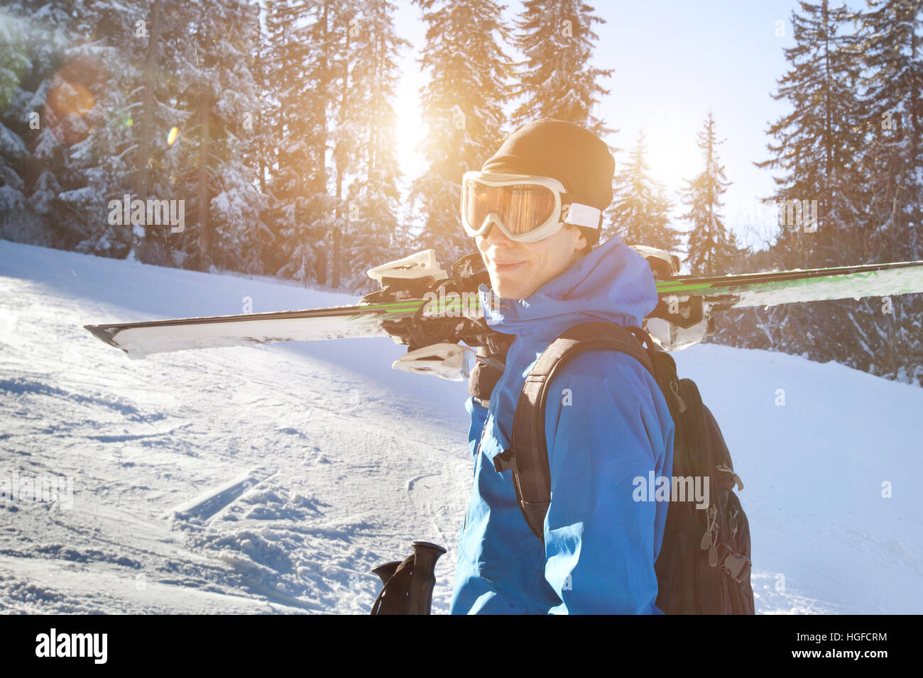 portrait of young happy smiling skier in goggles, active winter holidays Stock Photo