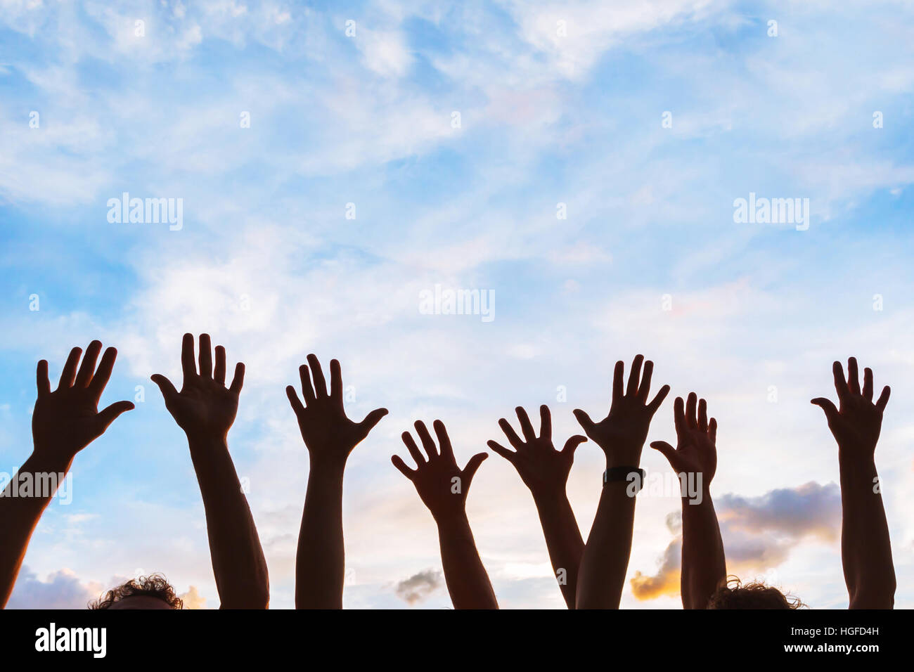 community initiative or volunteering concept, hands of group of people in the sky, silhouette Stock Photo