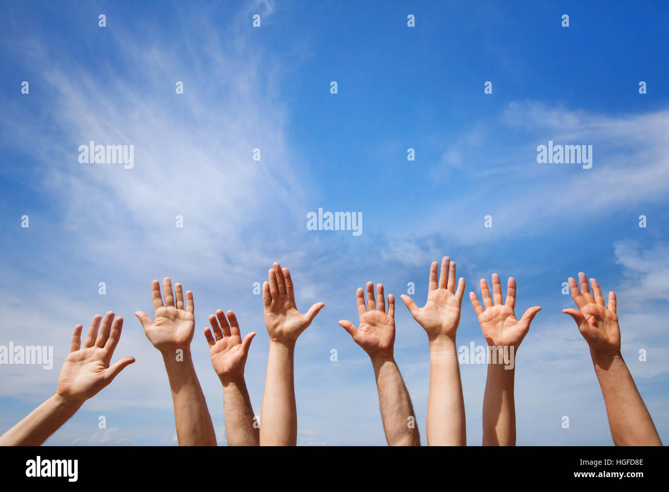 volunteering concept, hands of group of people volunteers in blue sky Stock Photo