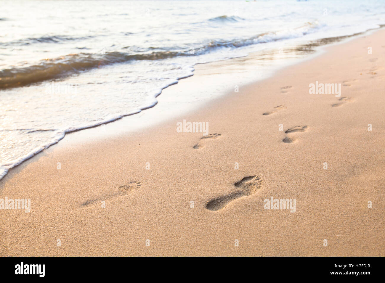 footprints of couple on the sand of beach Stock Photo