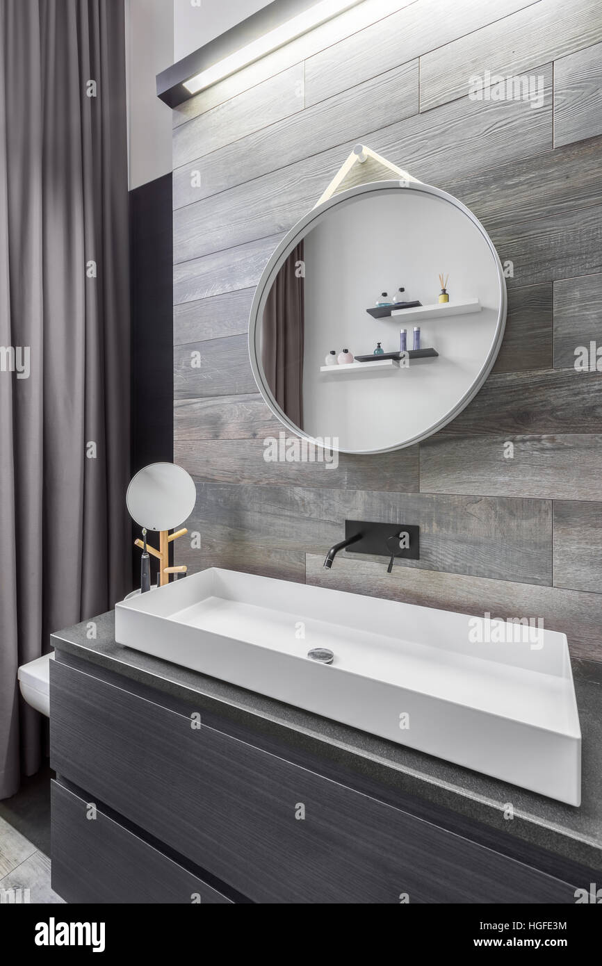 Bathroom with countertop washbasin and wood effect wall tiles Stock Photo -  Alamy