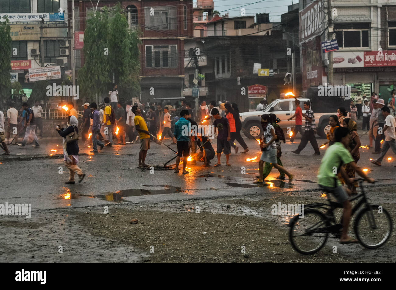 Nepal - circa May 2012: People walk on street and hold burning torches during Nepal general strike. Documentary editorial. Stock Photo