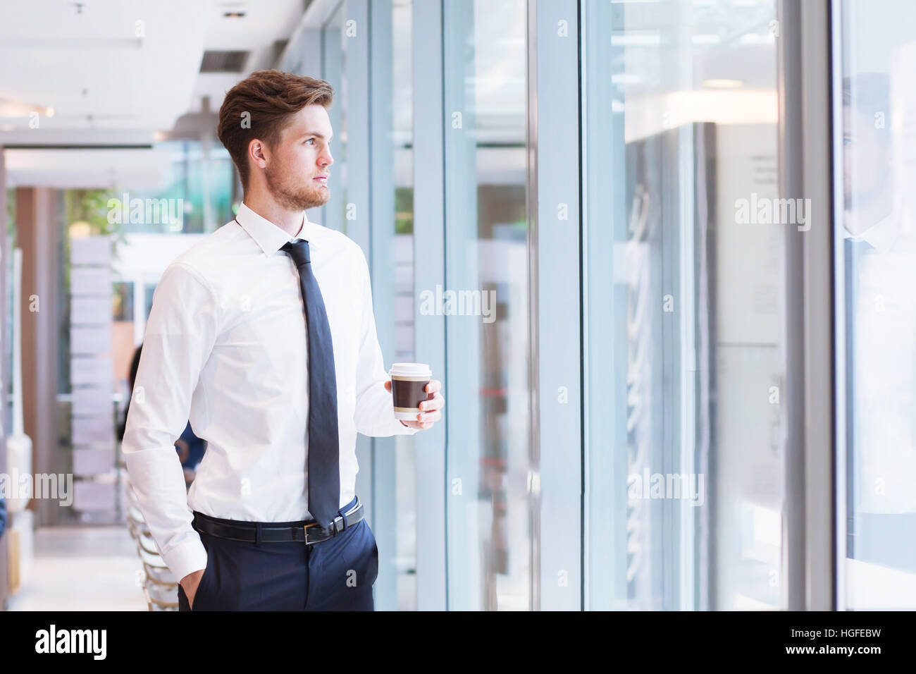 businessman looking at the window in the office and thinking Stock Photo