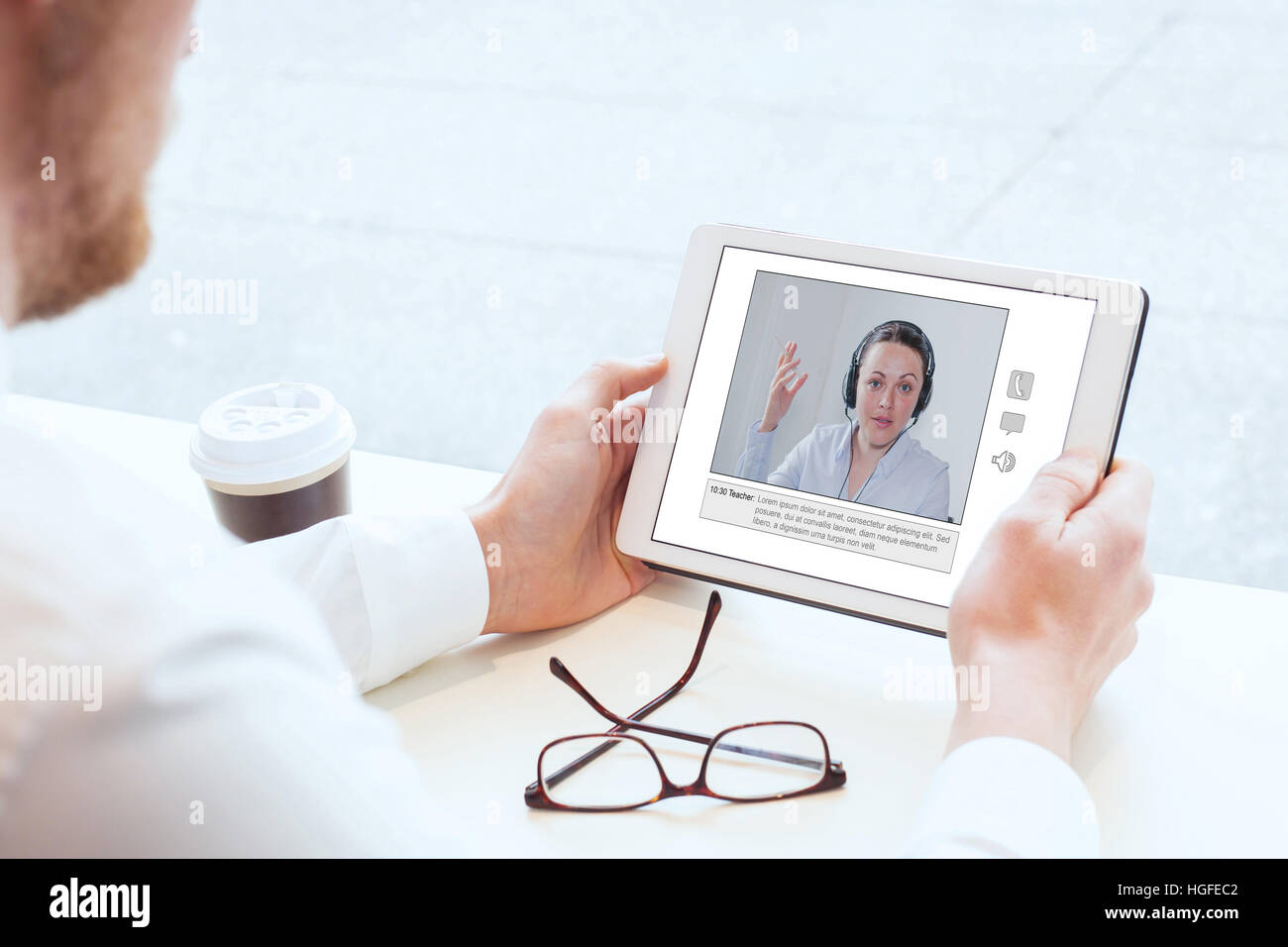 e-learning, video conference, coaching online, man looking at the screen of tablet Stock Photo