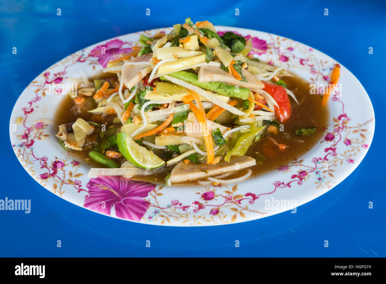 green papaya spicy salad Thai style on blue background Stock Photo Alamy
