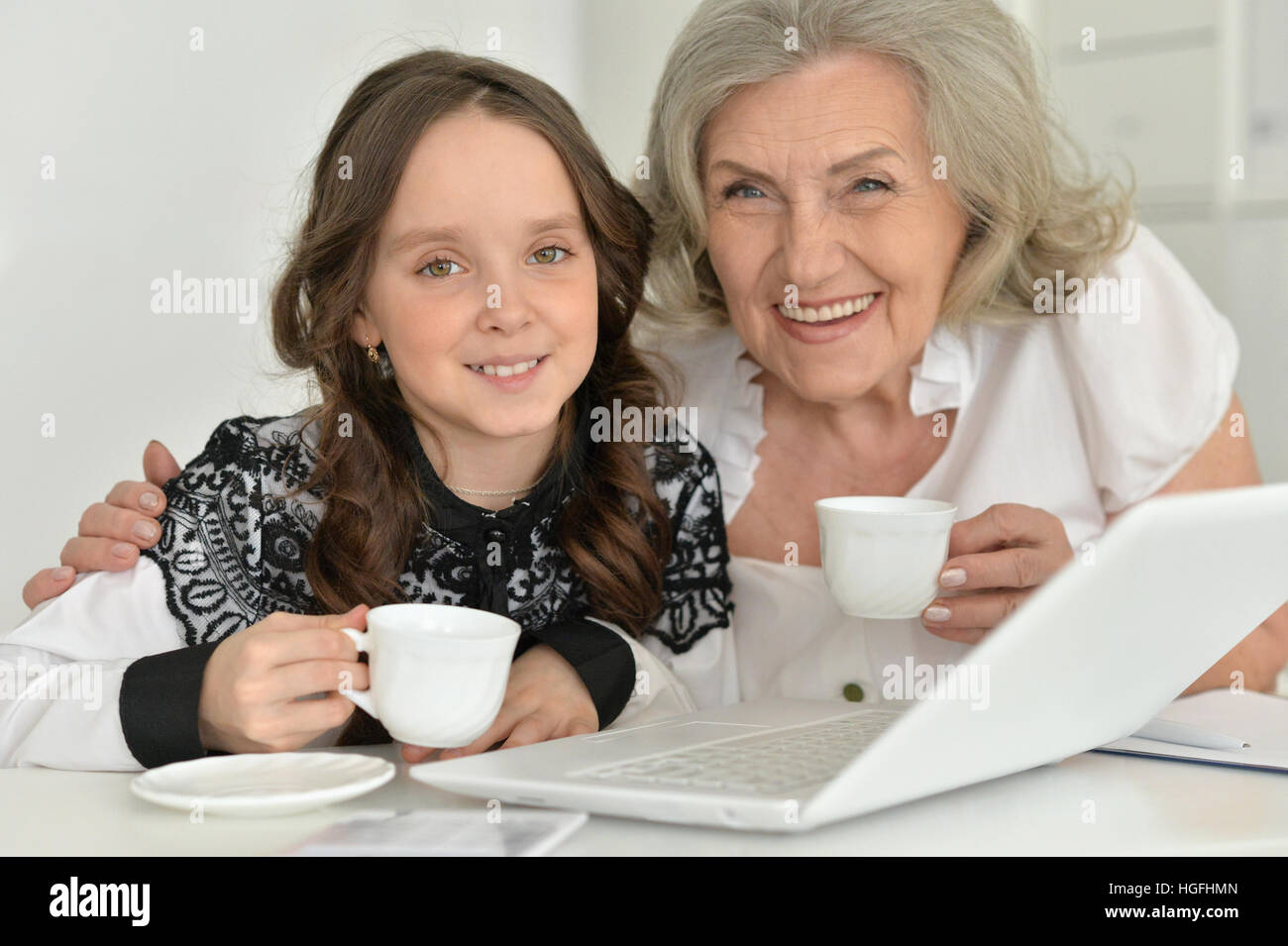 granny with granddaughter using laptop Stock Photo - Alamy
