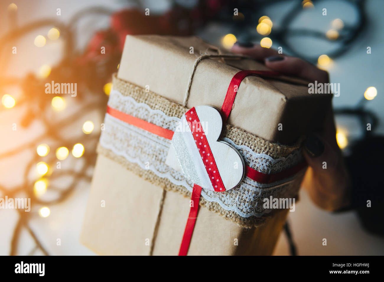 girl holding a Christmas gift in hand Stock Photo - Alamy