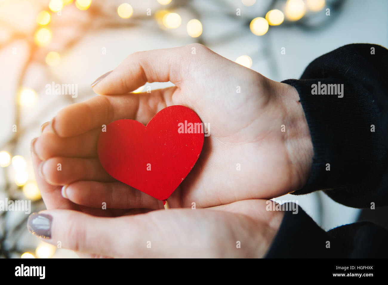 girl holding a red heart in the hands Stock Photo - Alamy
