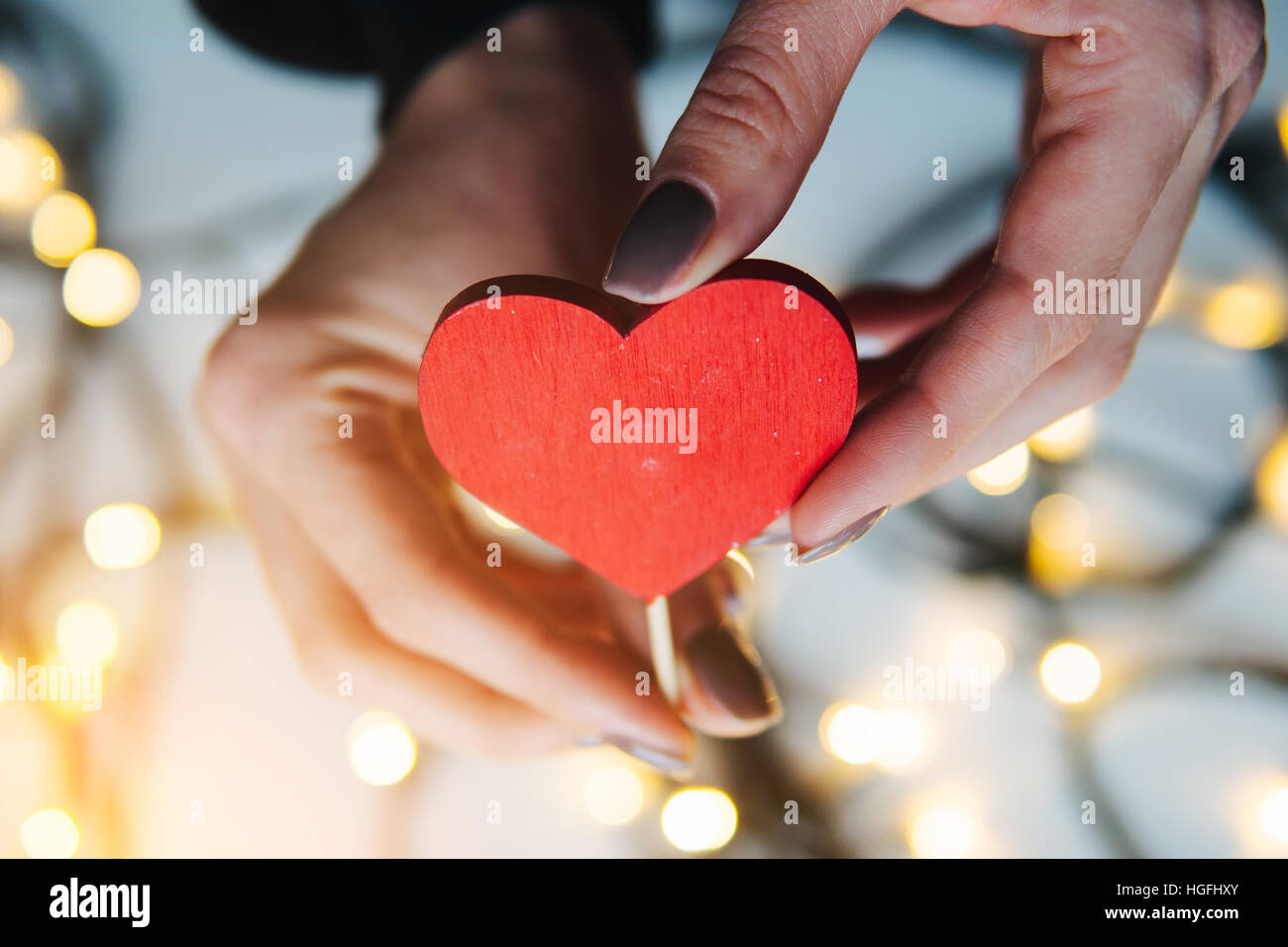 girl holding a red heart in the hands Stock Photo - Alamy