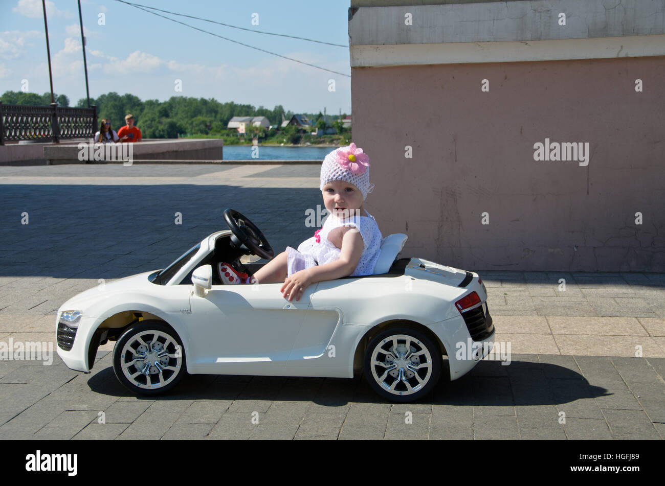 Siberian kid in a toy car, Irkutsk. Stock Photo