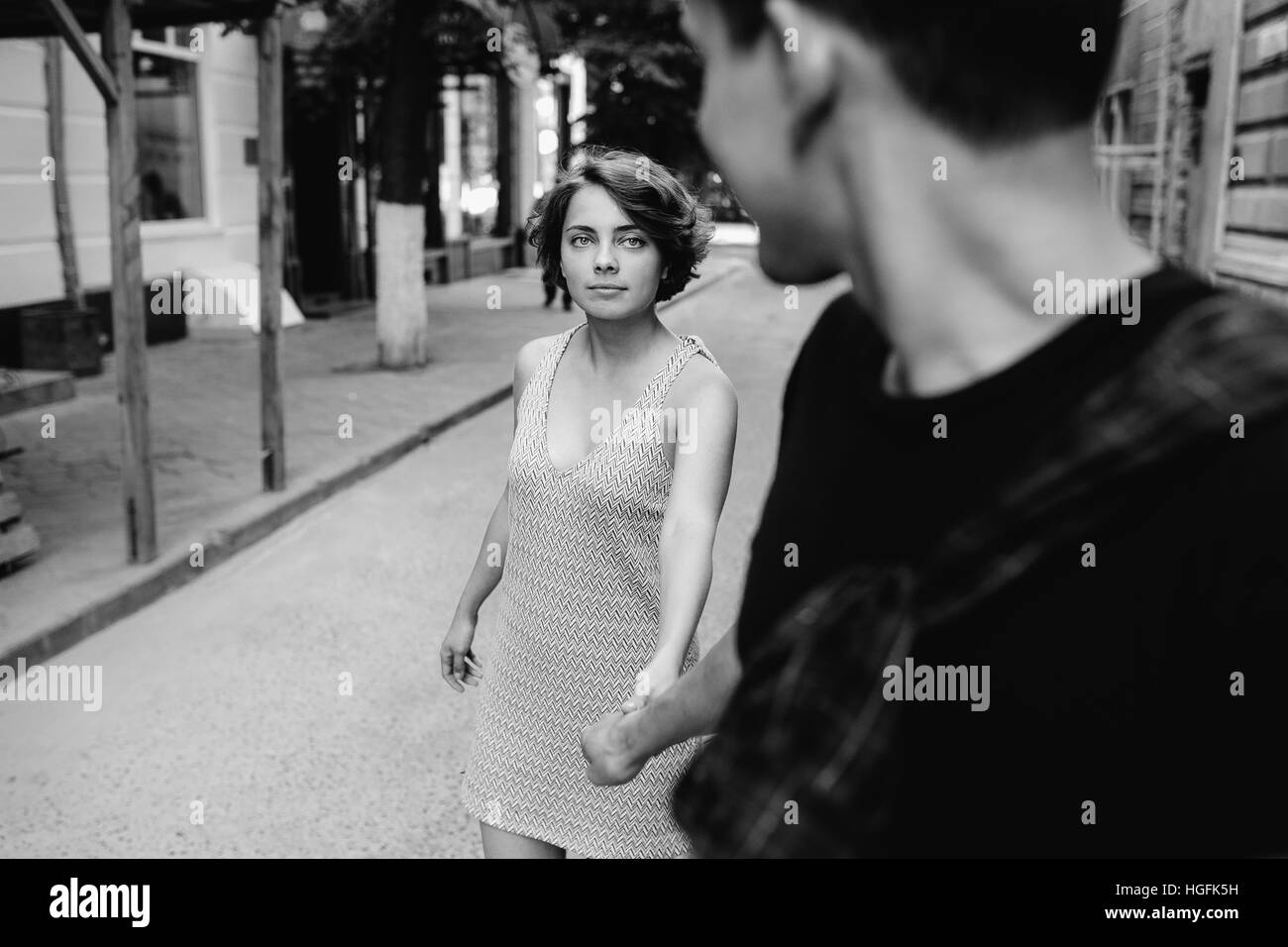 couple walking on the street holding hands Stock Photo - Alamy