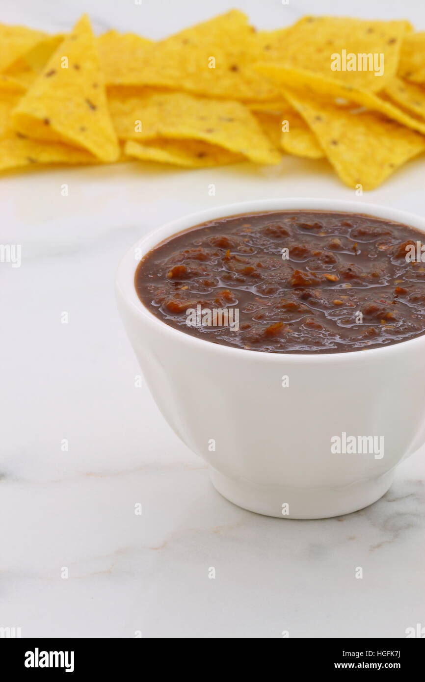 Artisan mexican chipotle sauce on vintage carrara marble table, with a delicious smoky flavor perfect for all your Mexican, tex-mex recipes and sides. Stock Photo