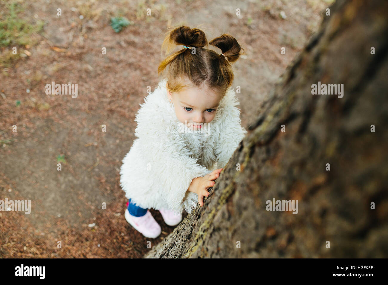 Cute little girl is playing outdoors Stock Photo - Alamy