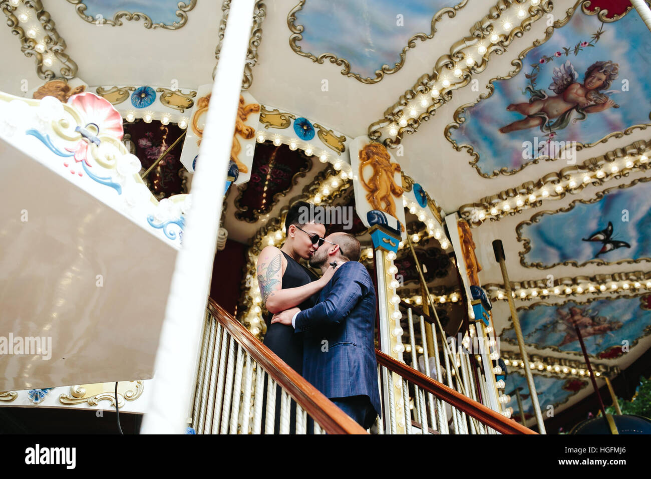 adult man and woman on a carousel Stock Photo