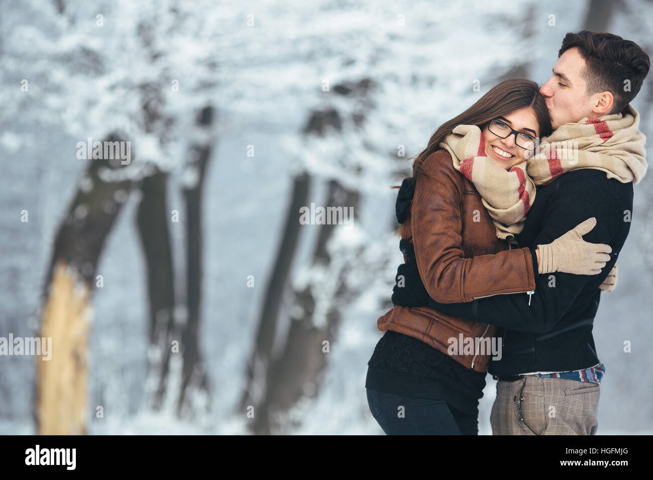 Happy couple in snow park Stock Photo - Alamy
