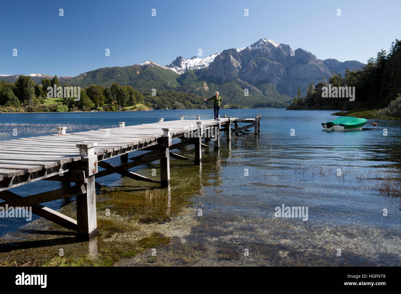 Wooden pier and snow-capped mountains on Lago Perito Moreno, Llao Llao, near Bariloche, Nahuel Huapi National Park, The Lake District, Argentina, Sout Stock Photo