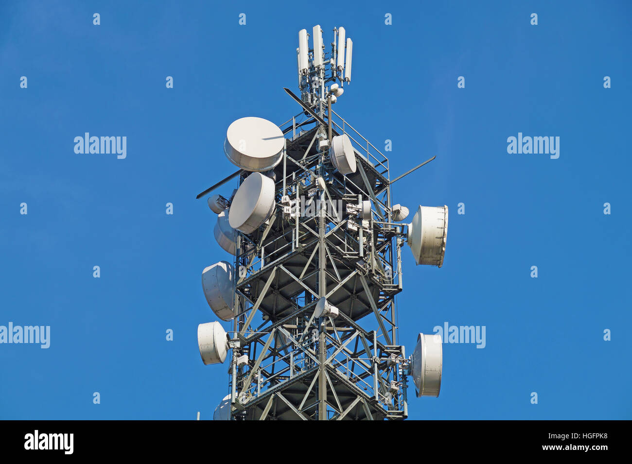 Telecommunication pole tower television antennas with blue sky Stock Photo