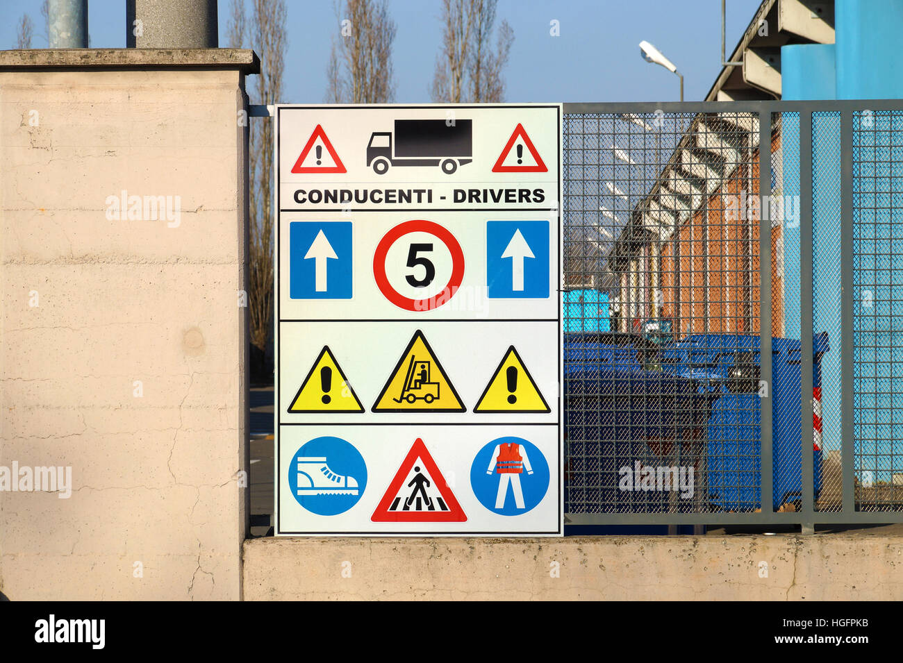 construction site sign with safety notices hanging on wall Stock Photo