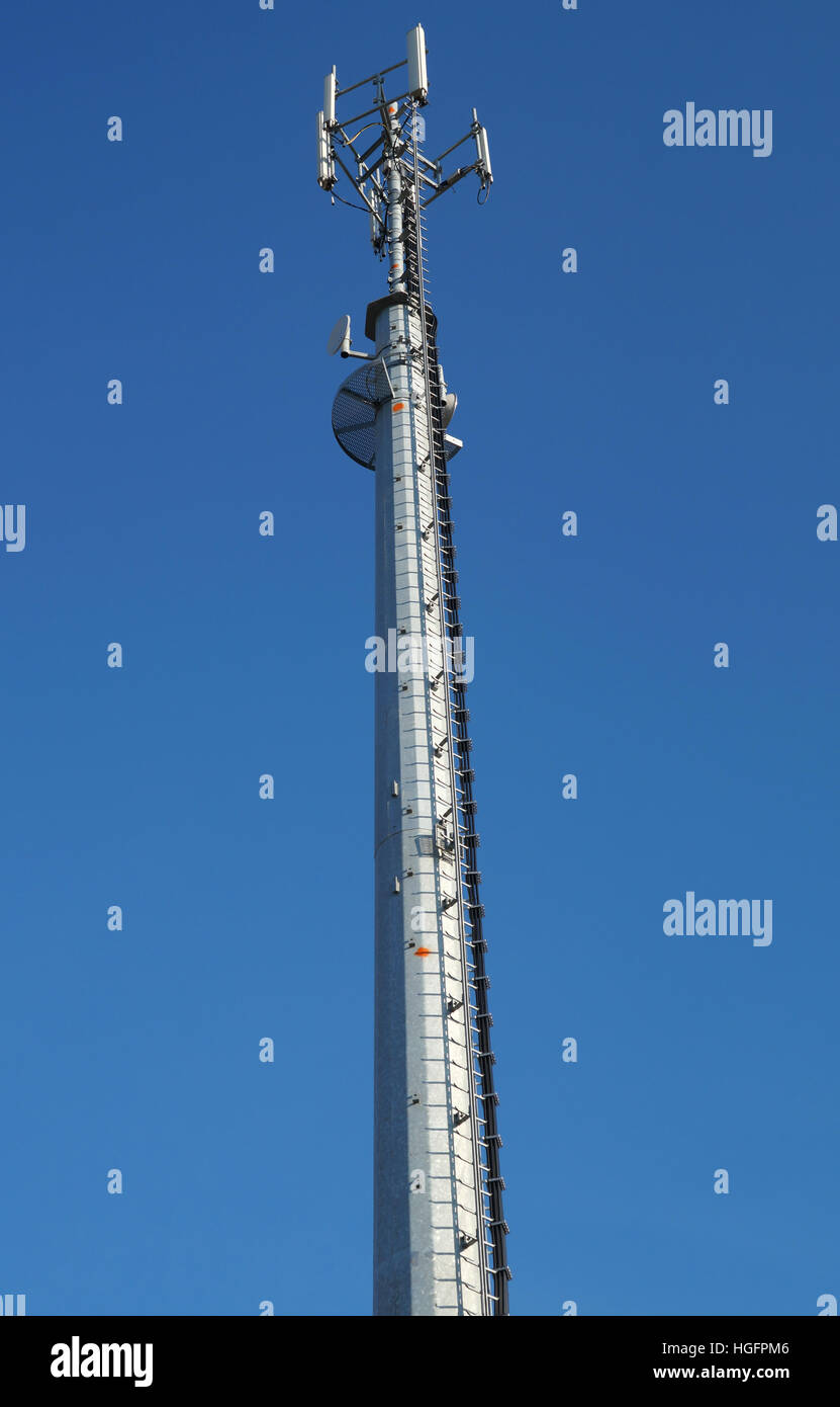 mobile pole behind tree with blue sky back ground ,technology can ...